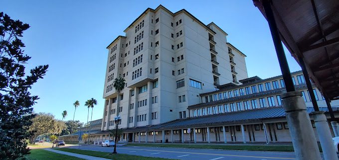 Modern multi-story building with palm trees